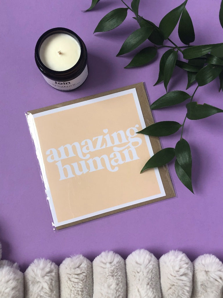 A yellow greetings card which says 'Amazing Human'.